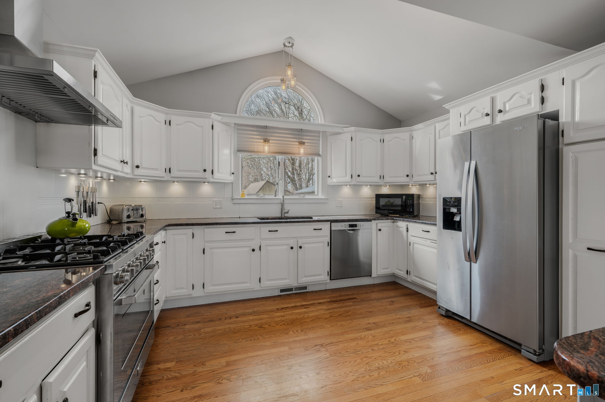 20 Coco Drive Colchester, CT 06415 - Photo 13 of 40 a kitchen with white cabinets and stainless steel appliances