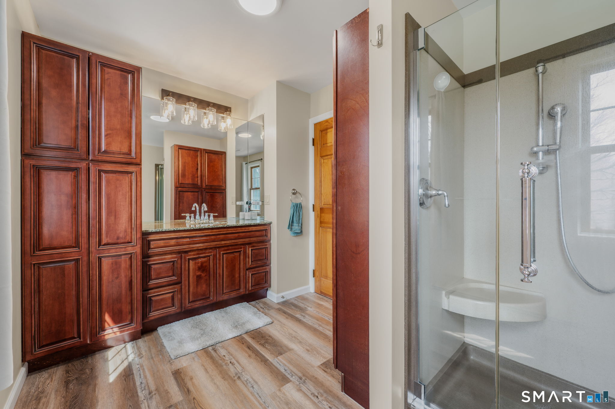 20 Coco Drive Colchester, CT 06415 - Photo 29 of 40 a bathroom with a glass door shower a sink and a mirror