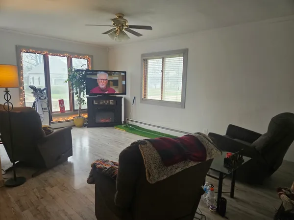 a living room with furniture and a flat screen tv
