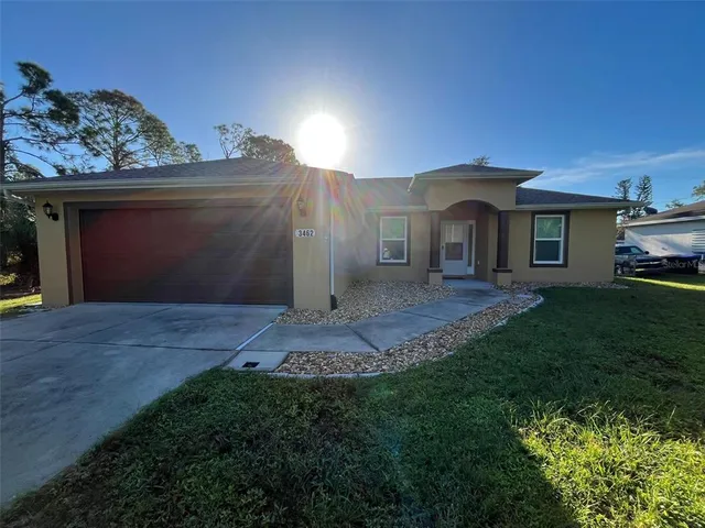 a front view of a house with a yard and garage