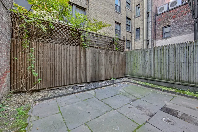 a view of a pathway gate with wooden fence