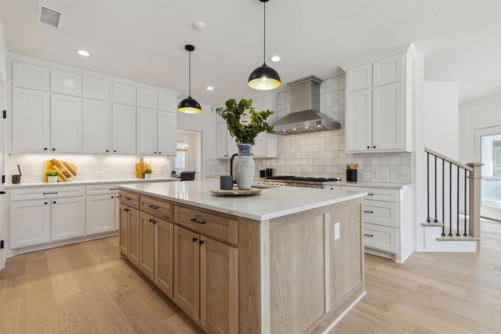 a kitchen with a white stove cabinets and white cabinets