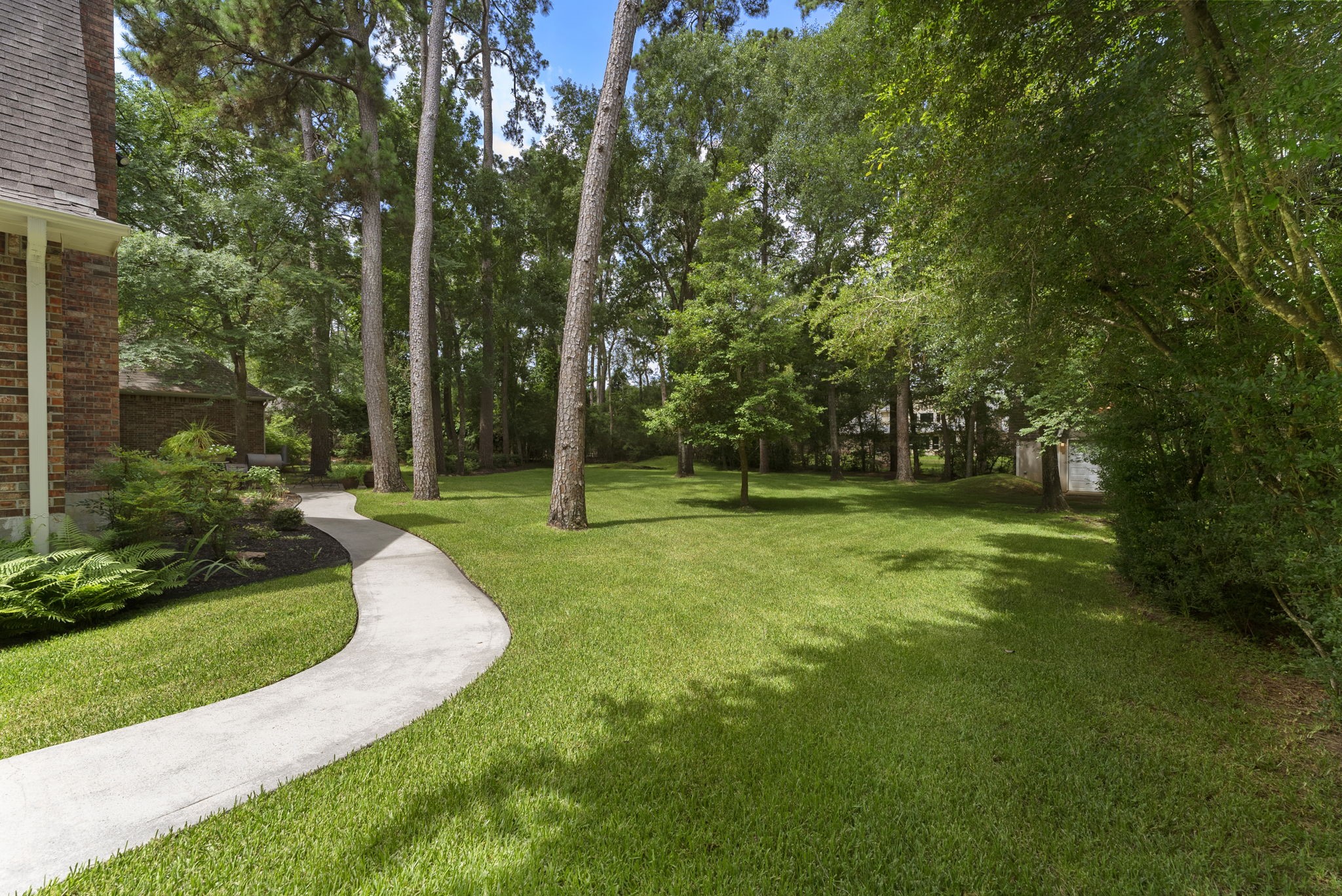 24311 Standing Oak Drive Spring, TX 77389 - Photo 39 of 42 Side view from driveway looking of the backyard. Beautiful and tons of room to expand your outdoor living space.