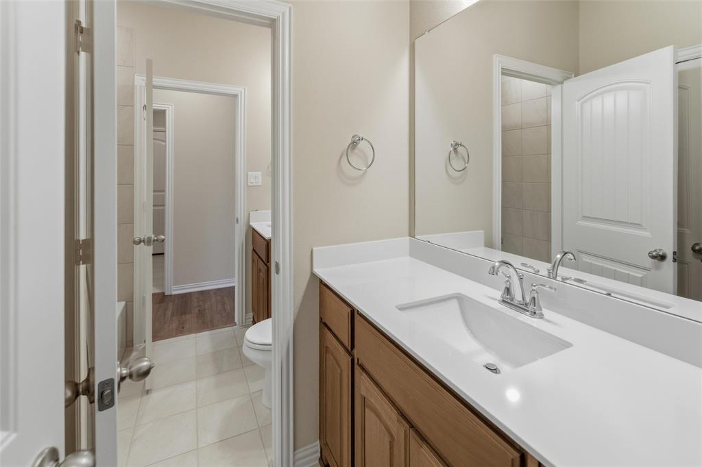 1229 Sabine River Lane Springtown, TX 76082 - Photo 10 of 26 a bathroom with a sink a toilet and shower