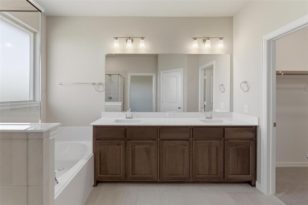 1229 Sabine River Lane Springtown, TX 76082 - Photo 17 of 26 a spacious bathroom with a double vanity sink mirror and double