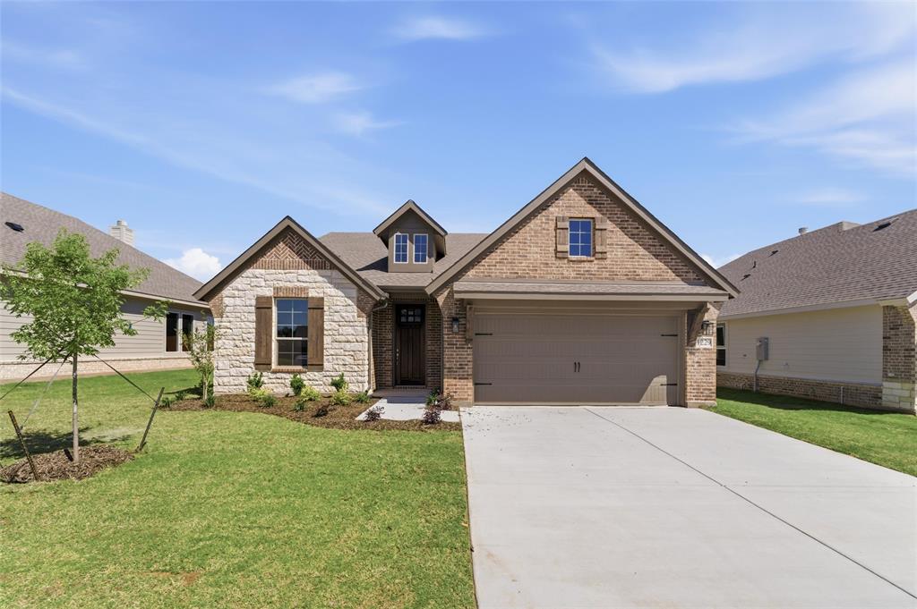 1229 Sabine River Lane Springtown, TX 76082 - Photo 2 of 26 a front view of a house with garden