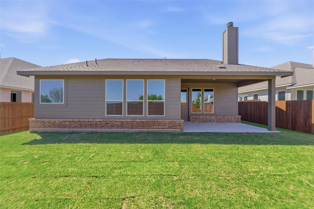 1229 Sabine River Lane Springtown, TX 76082 - Photo 23 of 26 a front view of a house with a garden