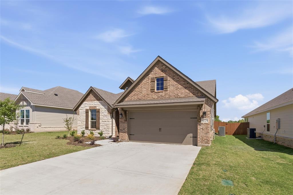 1229 Sabine River Lane Springtown, TX 76082 - Photo 3 of 26 a front view of a house with a yard