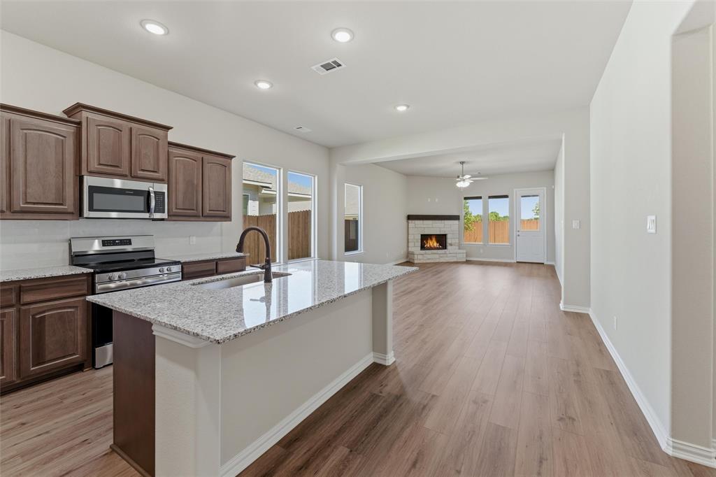 1229 Sabine River Lane Springtown, TX 76082 - Photo 26 of 26 a large kitchen with stainless steel appliances granite countertop a lot of counter space and wooden floor