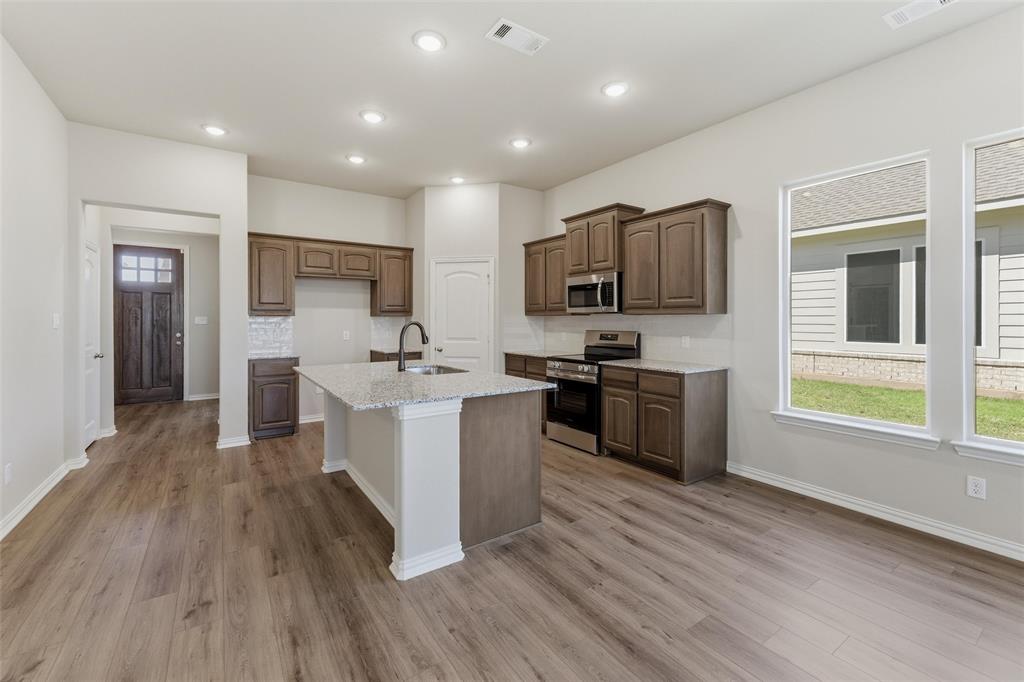 1229 Sabine River Lane Springtown, TX 76082 - Photo 8 of 26 a kitchen with a sink cabinets and stainless steel appliances