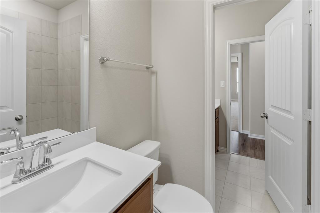 1229 Sabine River Lane Springtown, TX 76082 - Photo 9 of 26 a bathroom with a sink toilet and shower