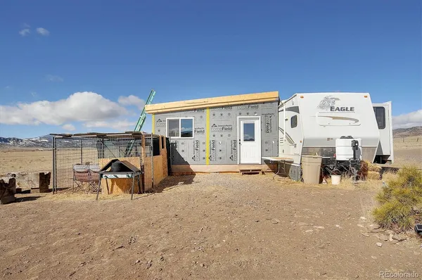 a view of a house with backyard porch and sitting area