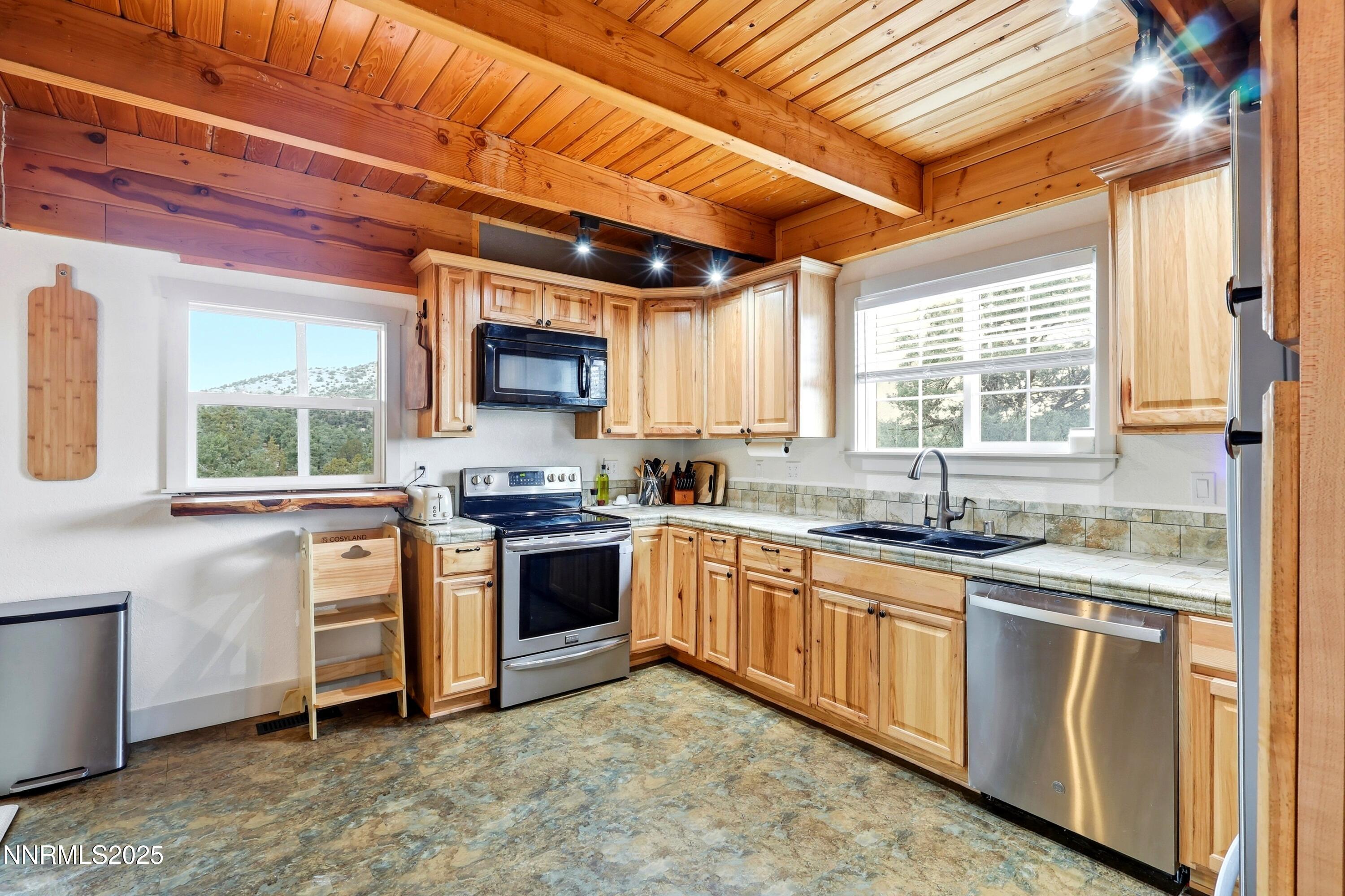 1590 Combination Road Reno, NV 89521 - Photo 22 of 41 a kitchen with stainless steel appliances granite countertop a stove sink and cabinets