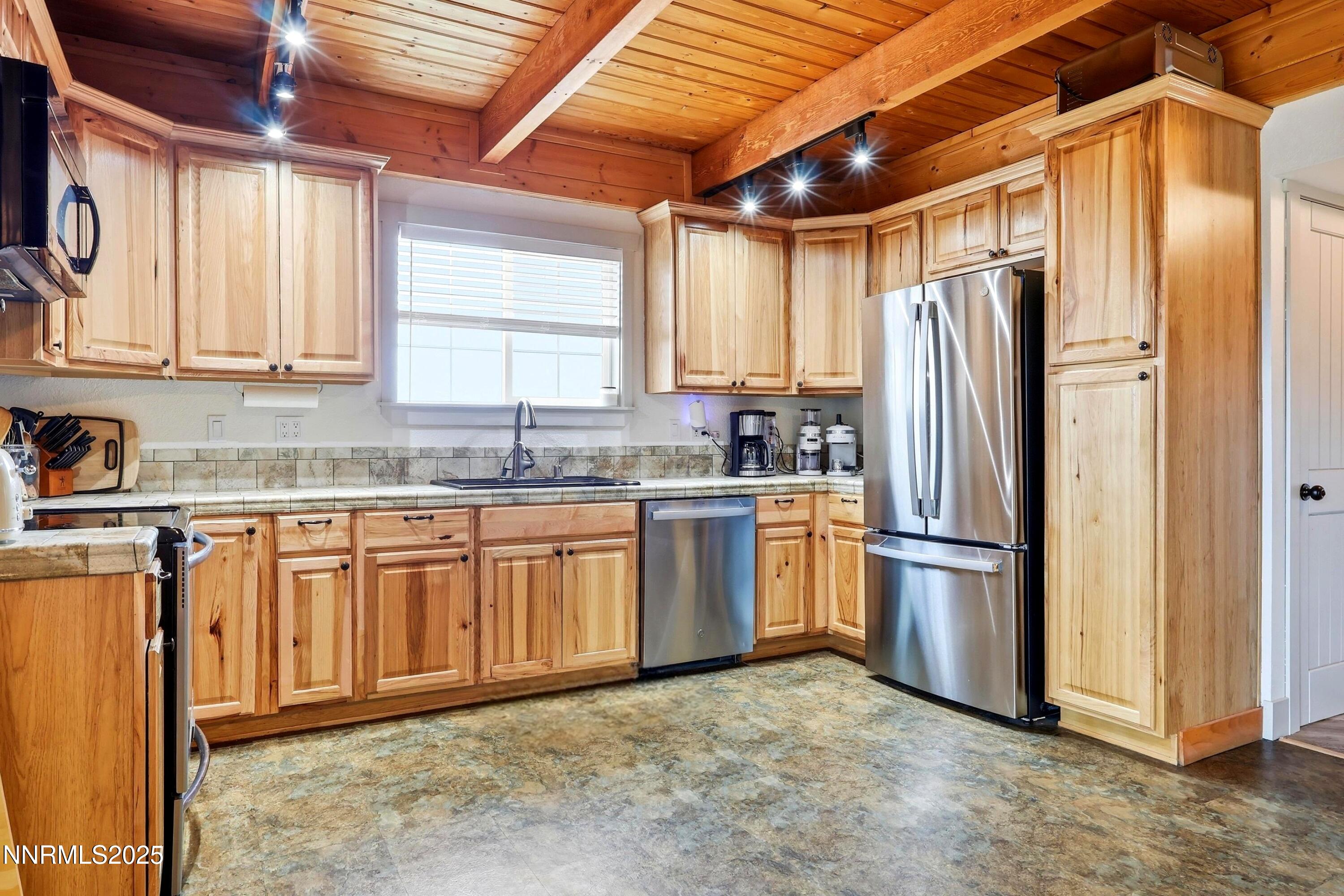 1590 Combination Road Reno, NV 89521 - Photo 23 of 41 a kitchen with stainless steel appliances granite countertop a refrigerator and a sink
