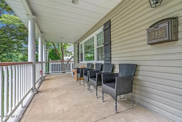 a view of a patio with table and chairs with wooden floor and fence
