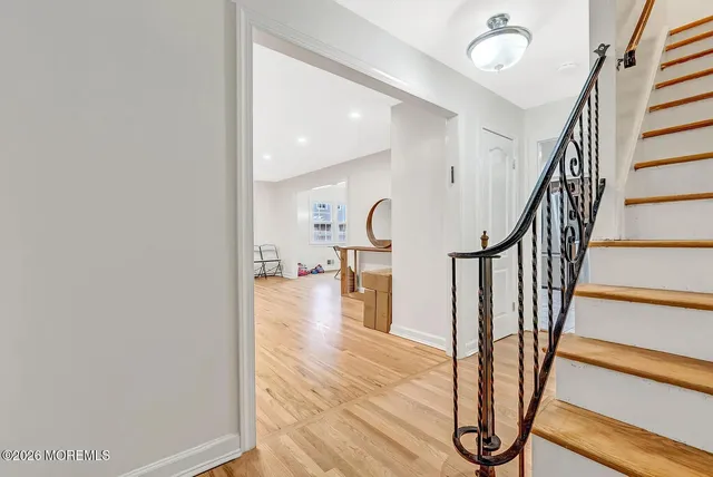 a view of entryway with wooden floor and stairs