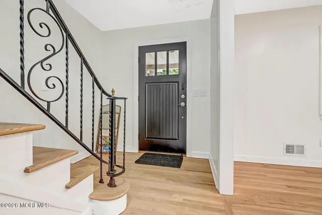 a view of an entryway with wooden floor