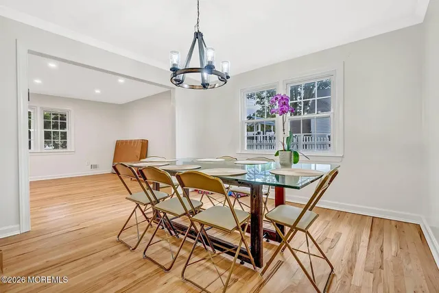 a view of a dining room with furniture wooden floor and chandelier