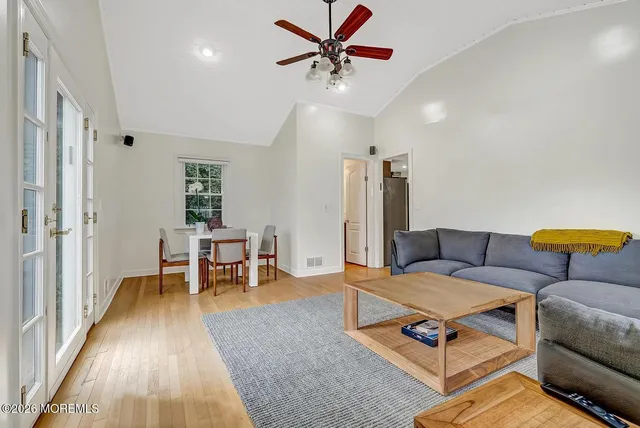a living room with furniture a rug and a chandelier