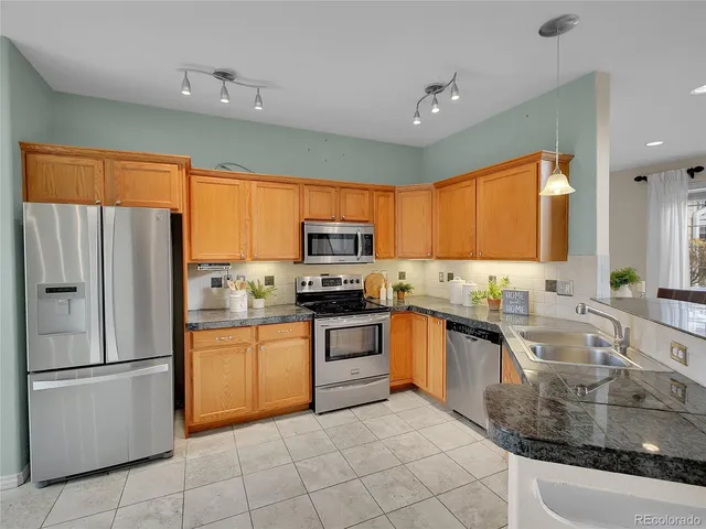 a kitchen with stainless steel appliances granite countertop a refrigerator sink and cabinets