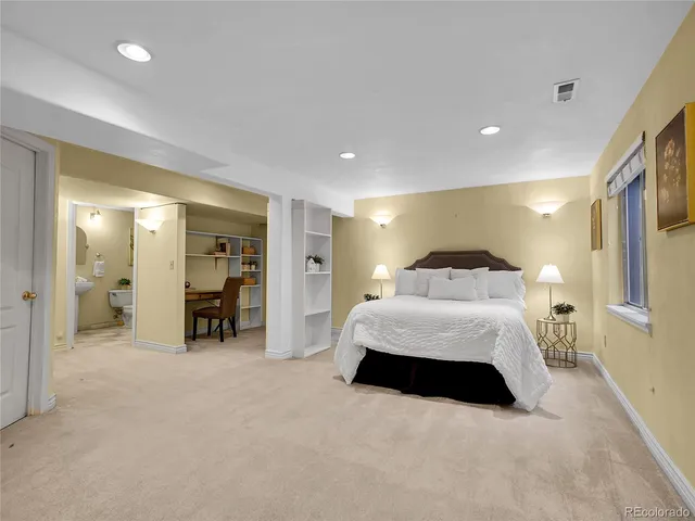 a spacious bedroom with a bed and a walk in closet