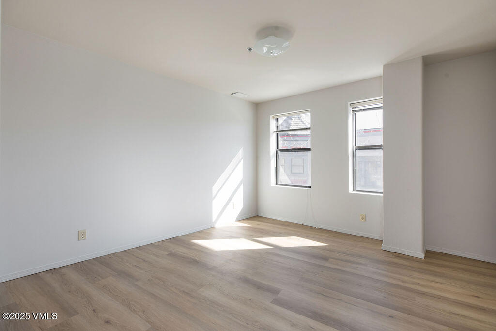 34295 Highway 6, Unit 201 Edwards, CO 81632 - Photo 3 of 15 an empty room with wooden floor and windows