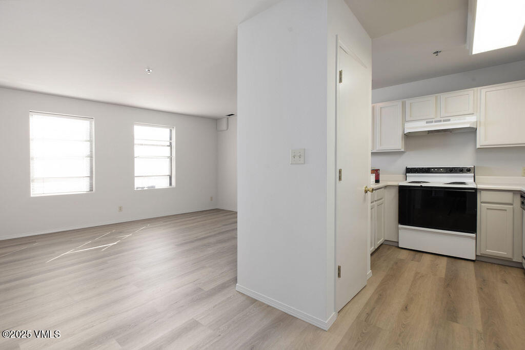 34295 Highway 6, Unit 201 Edwards, CO 81632 - Photo 5 of 15 a view of a kitchen with wooden floor and electronic appliances