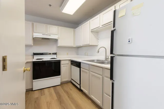 a kitchen with stainless steel appliances a sink and a stove