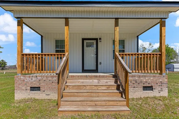 a view of entryway with wooden floor and a front door