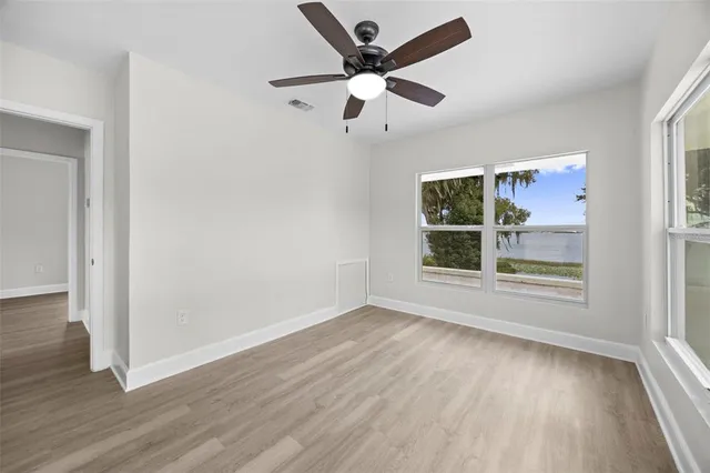 a view of a balcony with wooden floor and fence