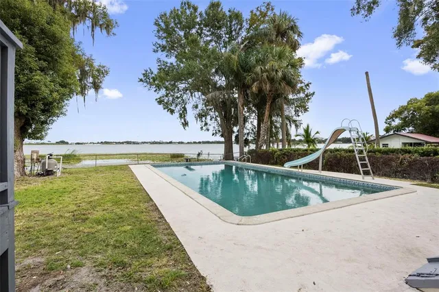 an empty room with a fireplace and wooden floor