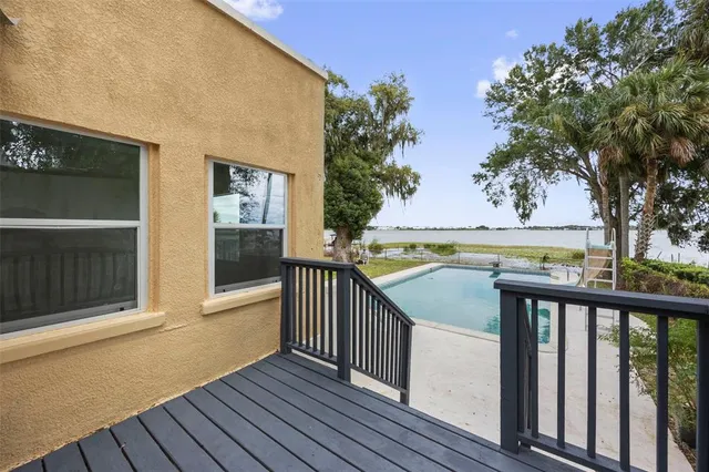 a view of balcony with wooden floor and fence