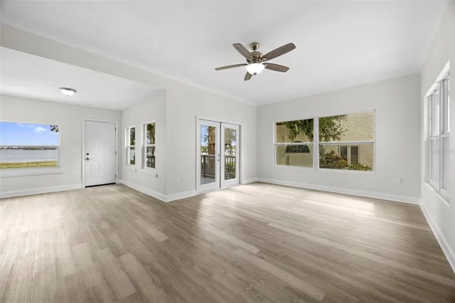 a view of a room with wooden floor ceiling fan