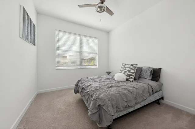 a bedroom with a bed and window