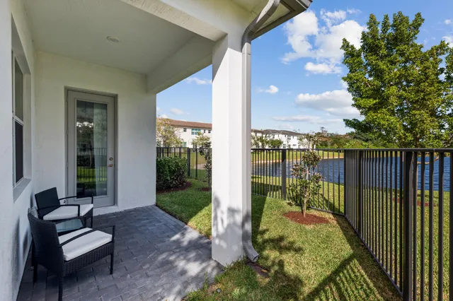 a view of a porch with furniture and garden