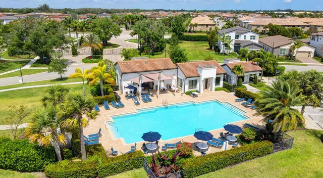 an aerial view of residential houses with outdoor space and swimming pool