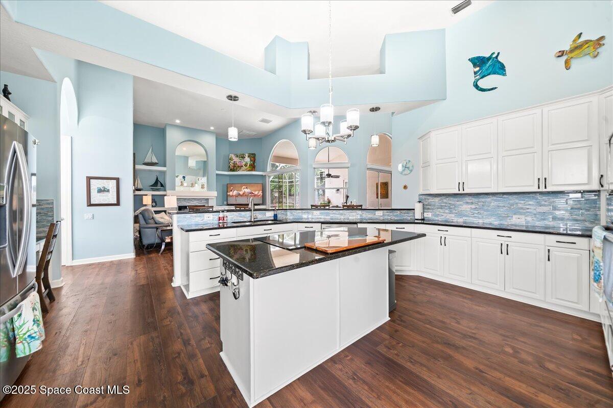 2089 Rockledge Drive Rockledge, FL 32955 - Photo 13 of 60 a kitchen with a sink stove and wooden floor