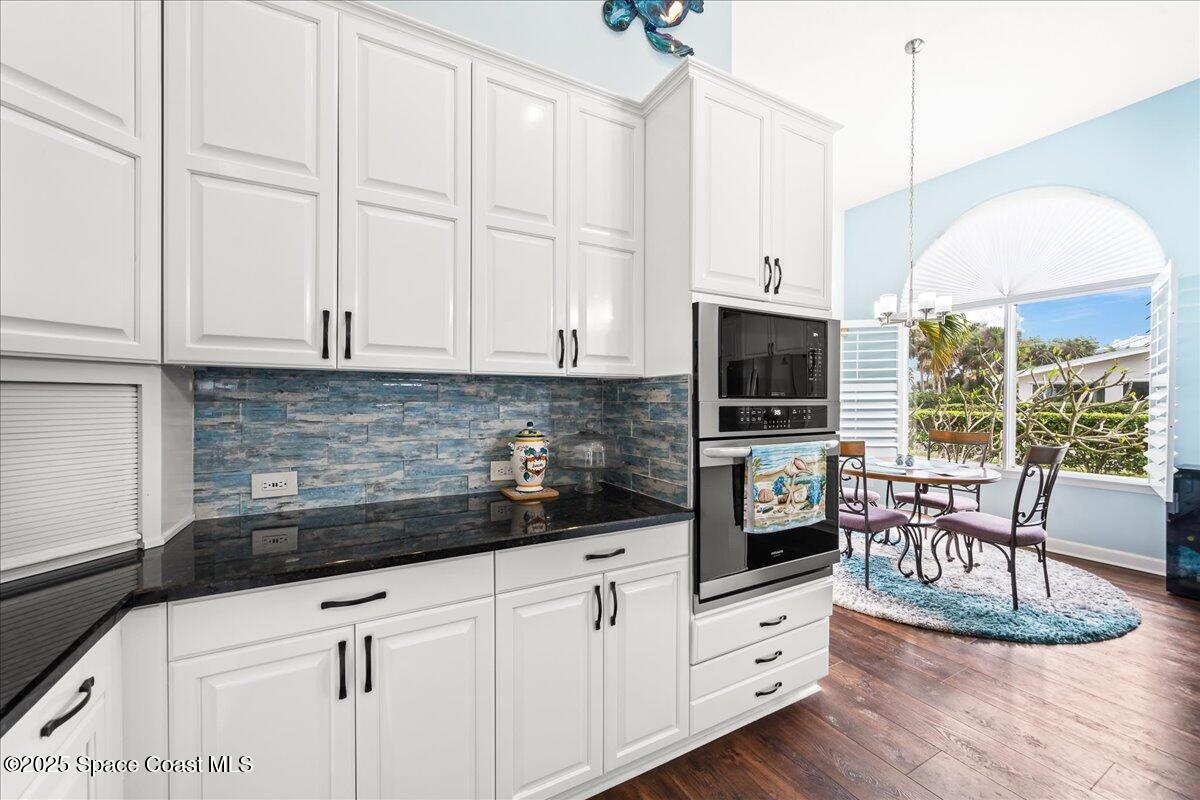 2089 Rockledge Drive Rockledge, FL 32955 - Photo 15 of 60 a kitchen with stainless steel appliances kitchen island granite countertop a stove a sink and white cabinets