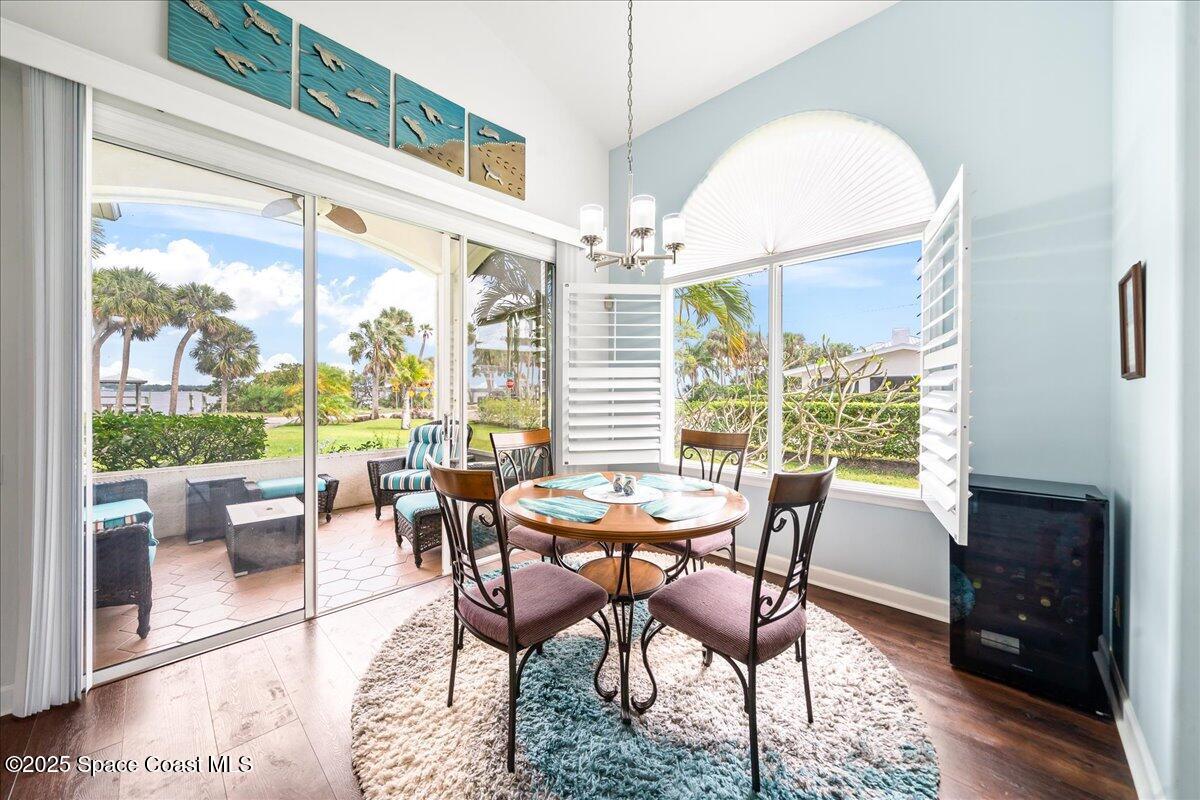 2089 Rockledge Drive Rockledge, FL 32955 - Photo 17 of 60 a dining room with furniture a chandelier and wooden floor