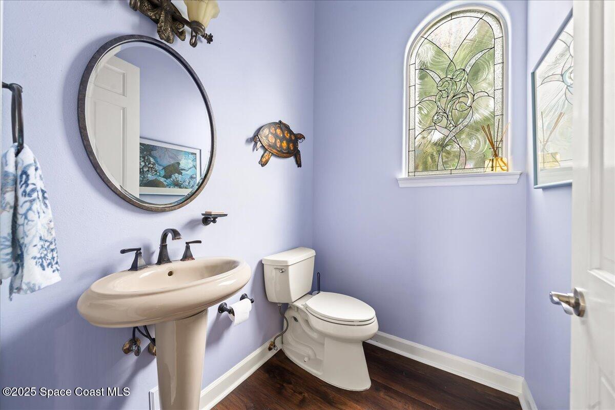 2089 Rockledge Drive Rockledge, FL 32955 - Photo 28 of 60 a bathroom with a toilet a sink and a mirror