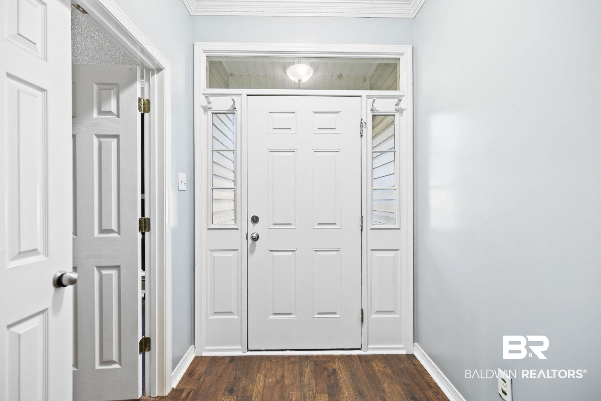 10550 Patrick Avenue Grand Bay, AL 36541 - Photo 9 of 43 Doorway to outside with ornamental molding and dark wood-type flooring