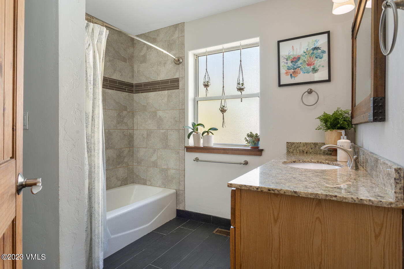 320 Golden Eagle Eagle, CO 81631 - Photo 13 of 26 a bathroom with a granite countertop sink a mirror a bathtub and shower