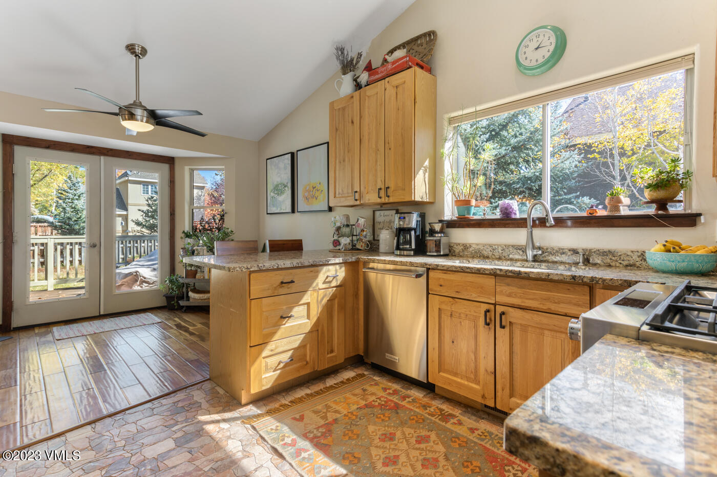 320 Golden Eagle Eagle, CO 81631 - Photo 8 of 26 a kitchen with stainless steel appliances granite countertop a stove a sink and a granite counter tops with garden view