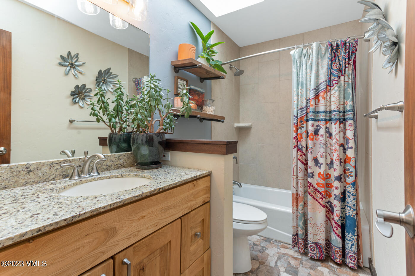 320 Golden Eagle Eagle, CO 81631 - Photo 10 of 26 a bathroom with a granite countertop sink a toilet and a shower curtain