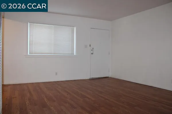 a view of a room that has wooden floor