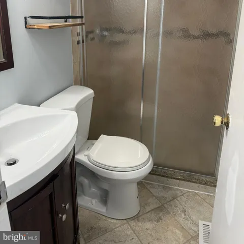 a white toilet sitting next to a bathroom sink