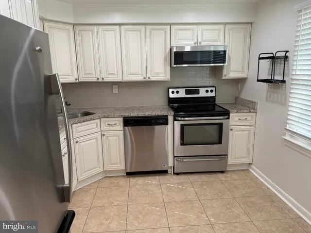 a kitchen with a stove and a microwave