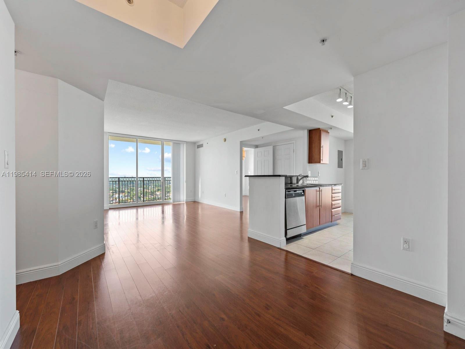 a view of a kitchen with wooden floor and a kitchen