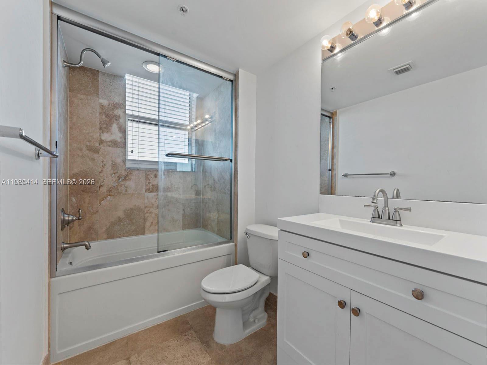 3232 Southwest 22nd Terrace, Unit 1609 Miami, FL 33145 - Photo 14 of 37 a bathroom with a sink a toilet and shower