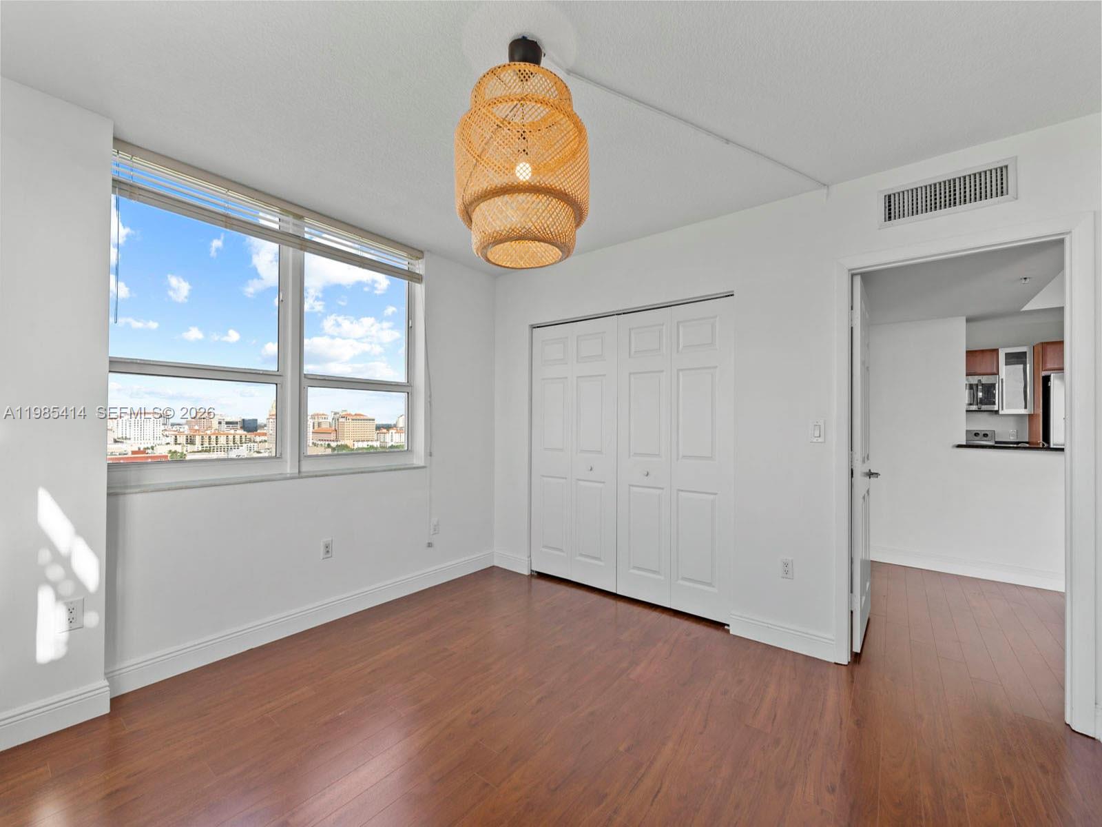 3232 Southwest 22nd Terrace, Unit 1609 Miami, FL 33145 - Photo 16 of 37 an empty room with wooden floor and windows